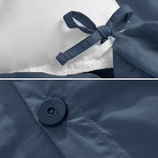 A close view of the corner tie of the duvet cover and the buttons for pillow shams