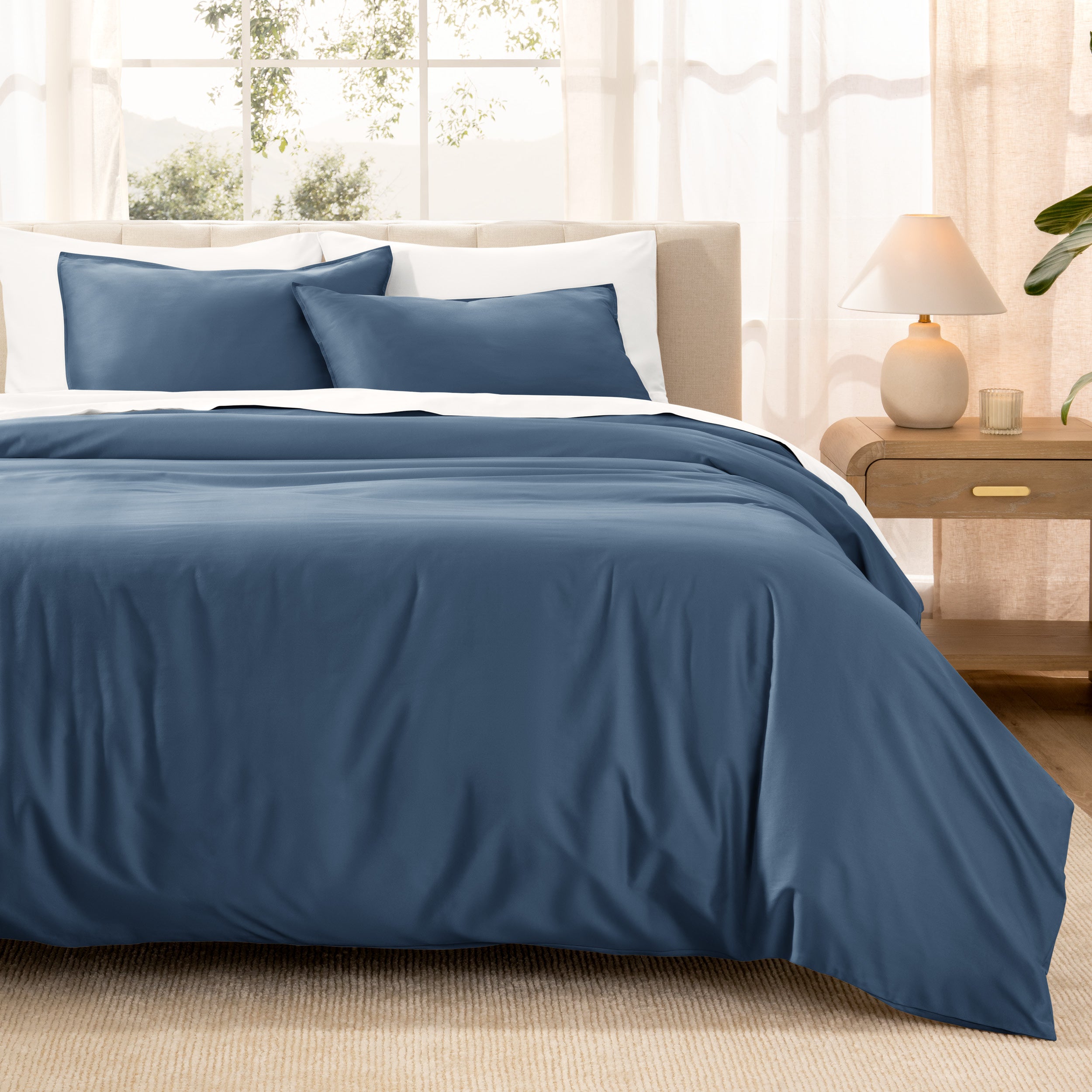 Warm bright room scene showing Sateen Duvet Set  laid out over the bed