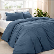 Angled view of bed with a duvet cover folded over on itself