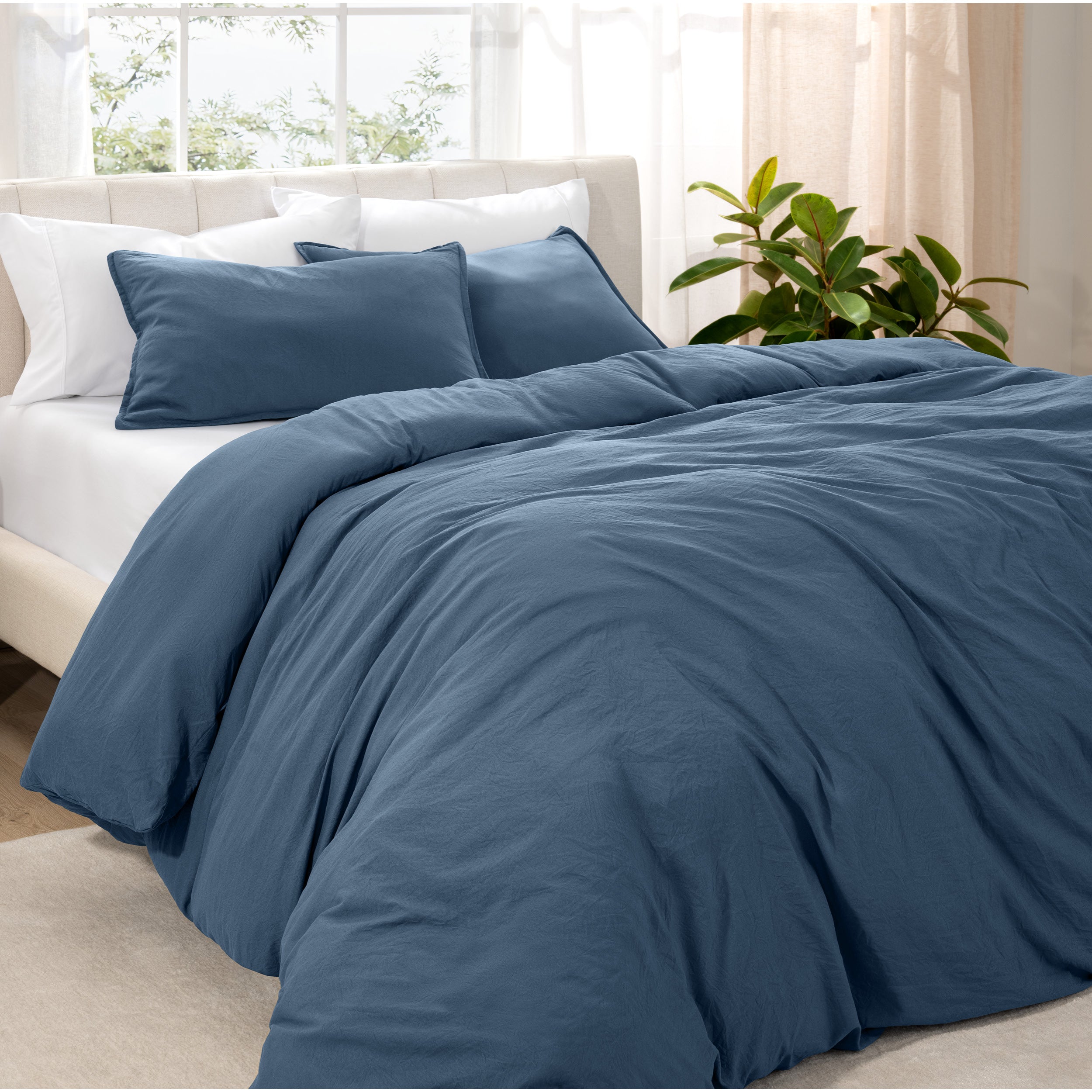 Angled view of bed with a duvet cover folded over on itself