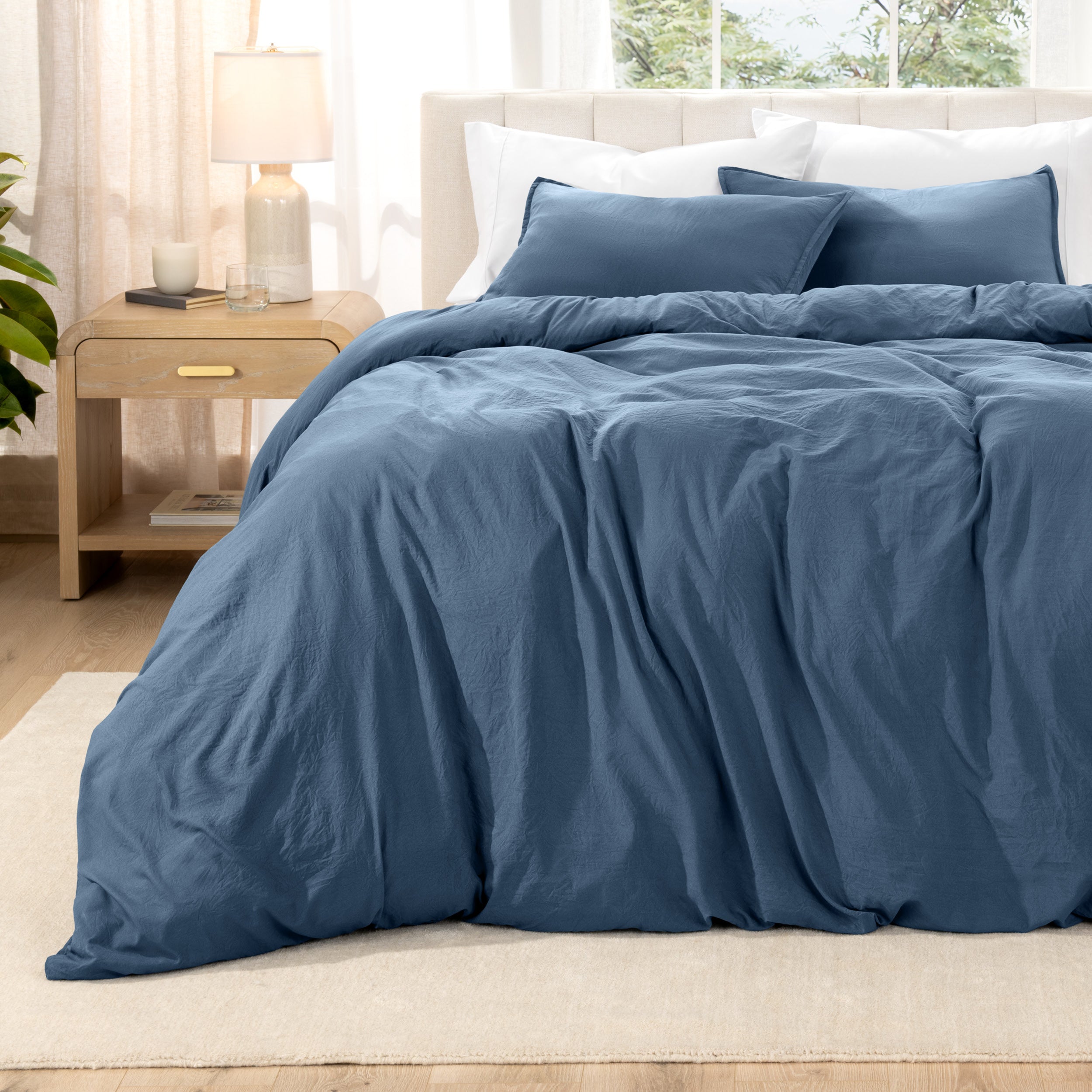 Relaxing room scene with a duvet cover laid out over the bed