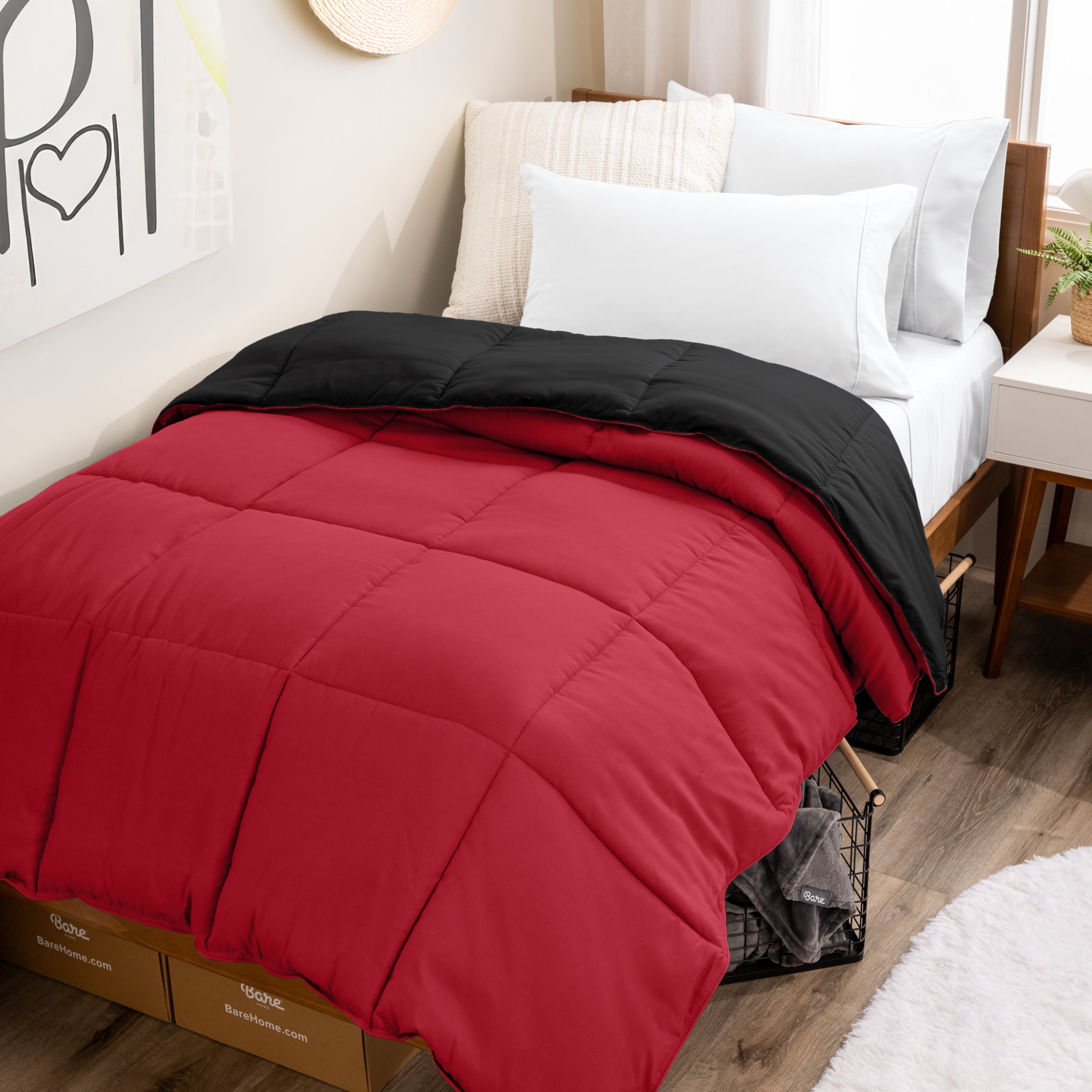Wooden bed frame with a reversible comforter on the bed. The comforter is folded back over showing the two different colors.