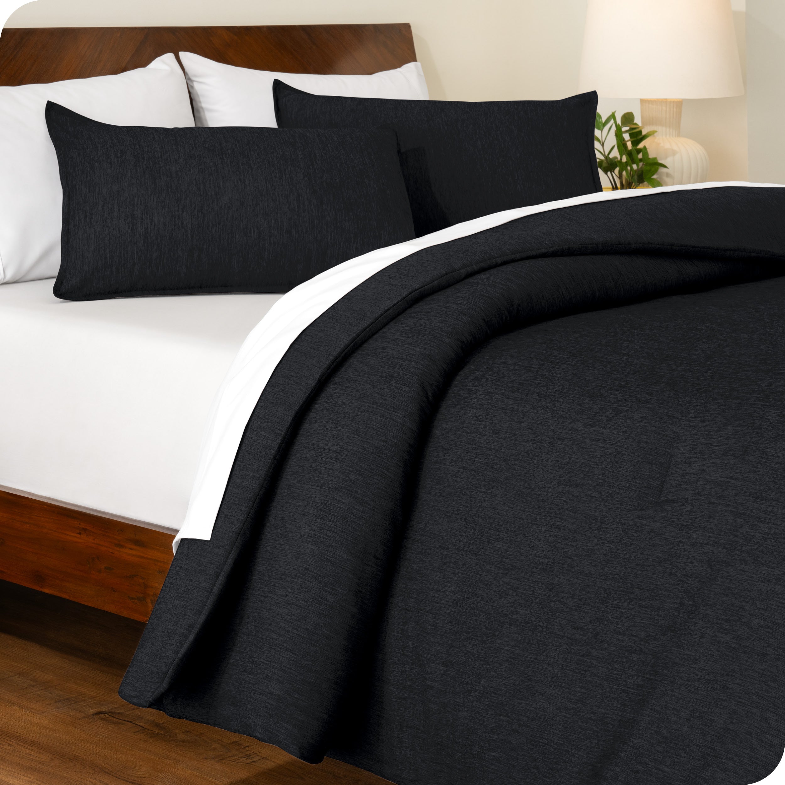 A side view of a bed made with a track stitch comforter set