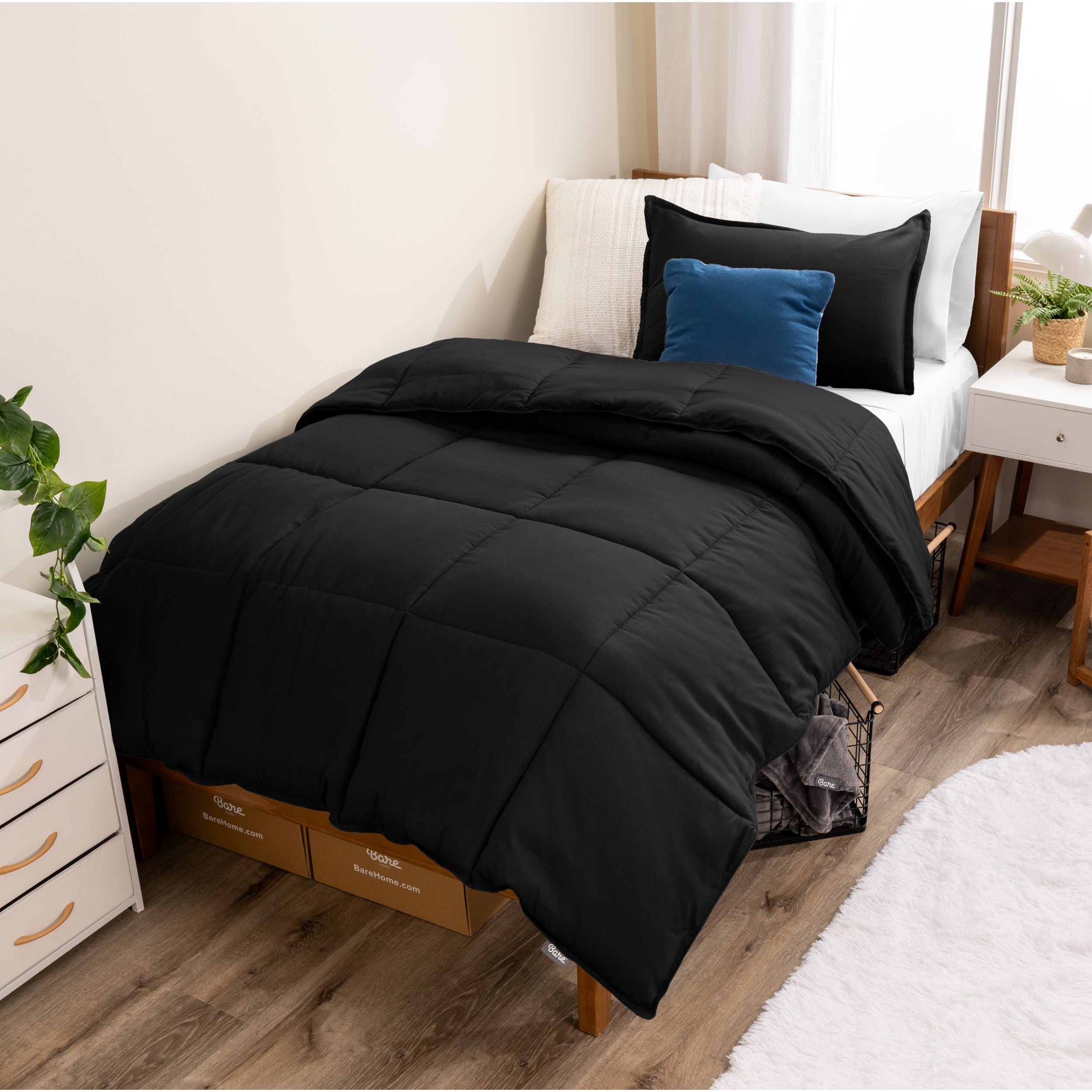 A modern bed with a down alternative comforter set on it