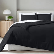 A comforter set on a bed in a bright modern room