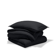 A comforter folded with a matching pillow sham stacked on top