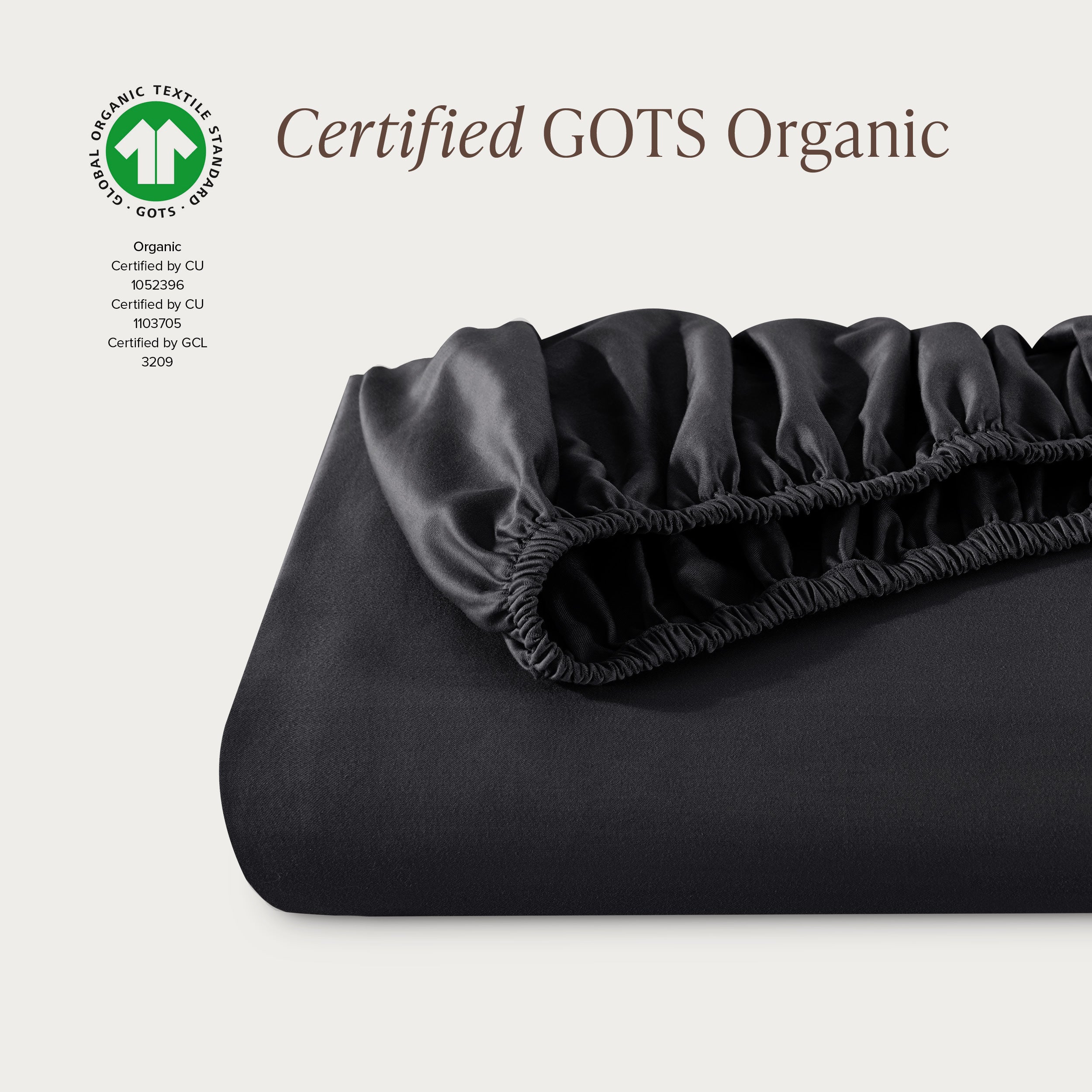 A single fitted sheet folded neatly showing part of the elastic. The fitted sheet is Certified GOTS Organic.