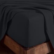A corner of bed with fitted sheet to show the deep pocket feature and the texture.