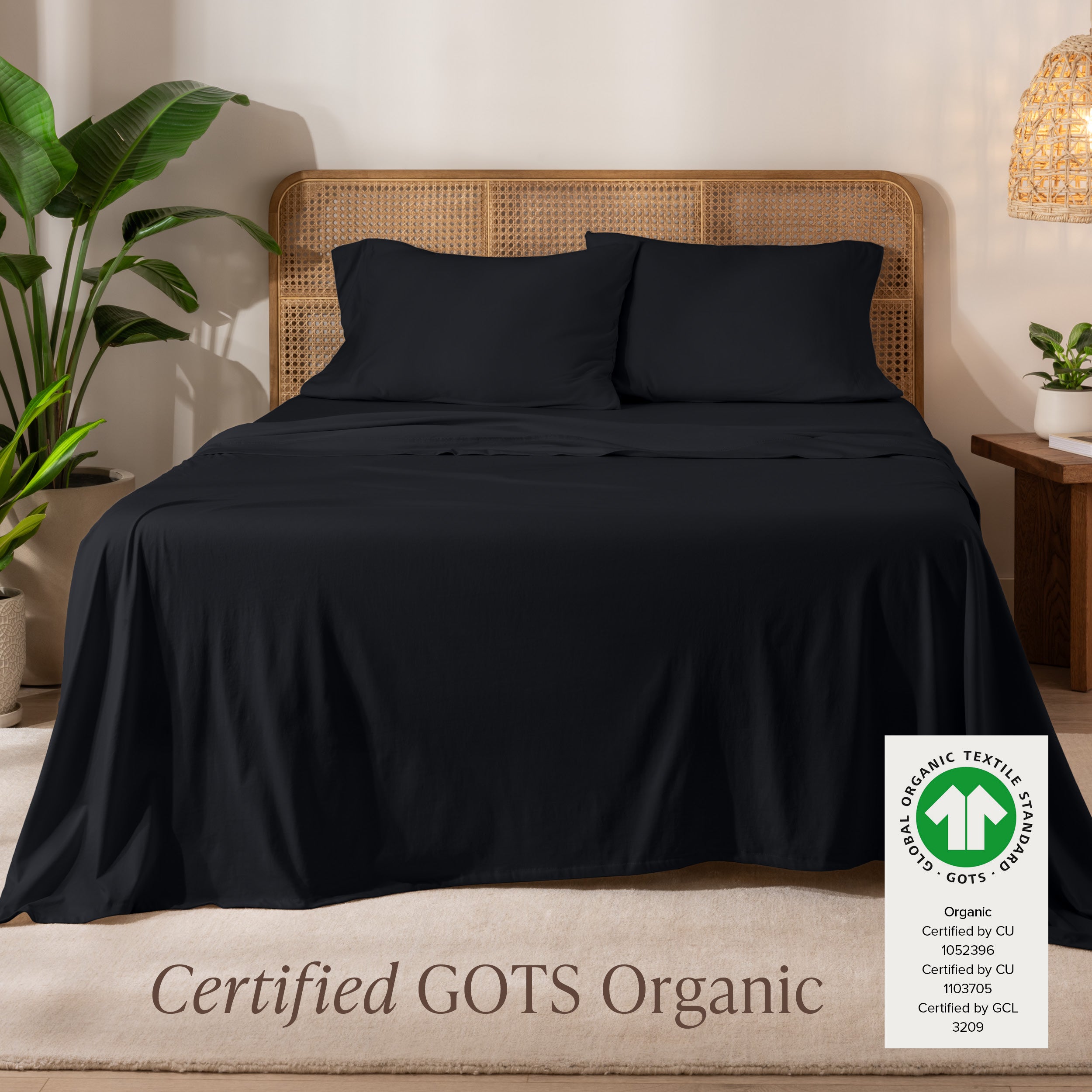 A bed in the middle of room with a set of Certified GOTS Organic Jersey Sheet Set on it.