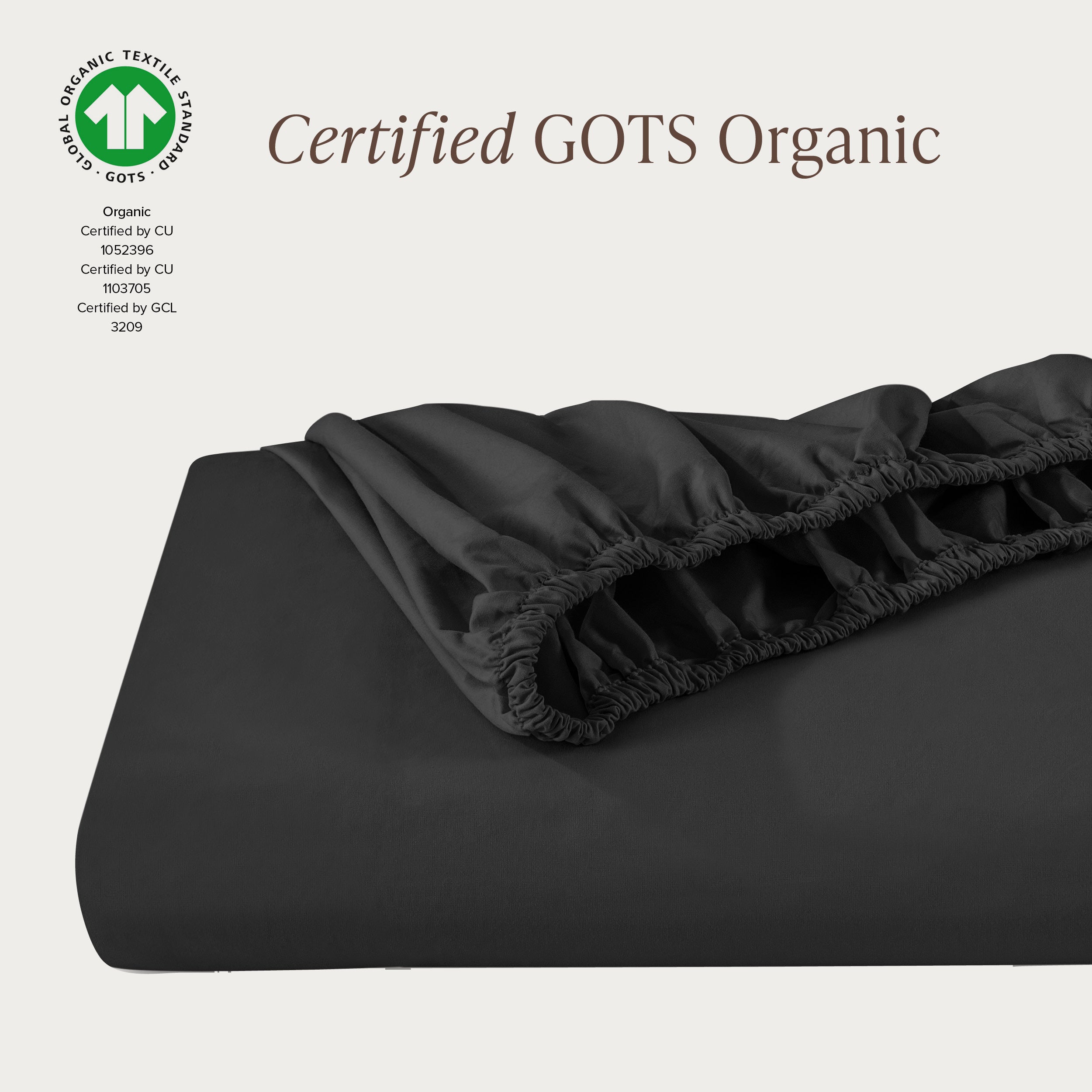 A single fitted sheet folded neatly showing part of the elastic. The fitted sheet is Certified GOTS Organic.