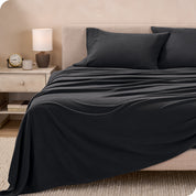 View of fleece sheets from the end of a bed with the top sheet draped over the side and end