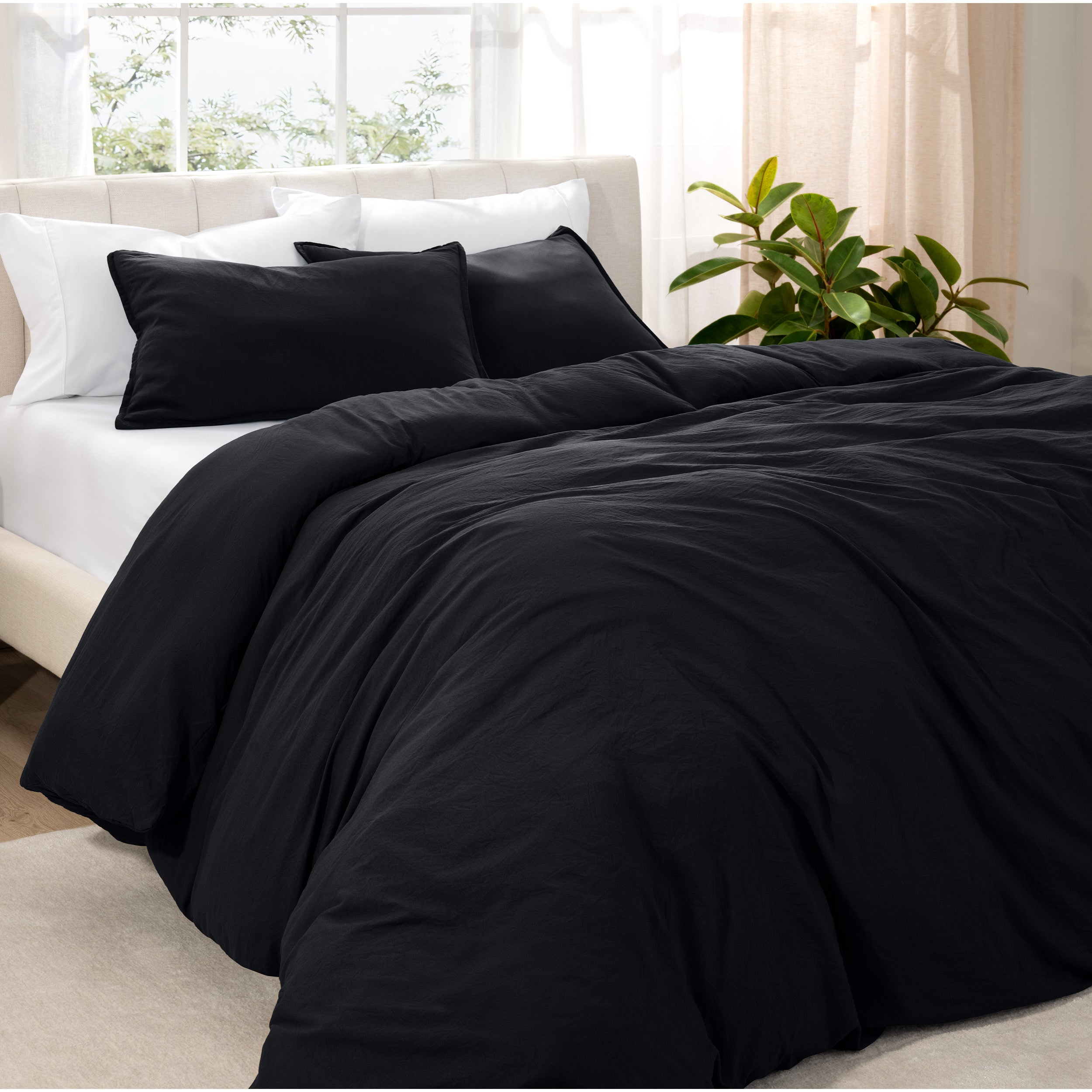 Angled view of bed with a duvet cover folded over on itself