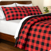 A side view of a bed made with a track stitch comforter set