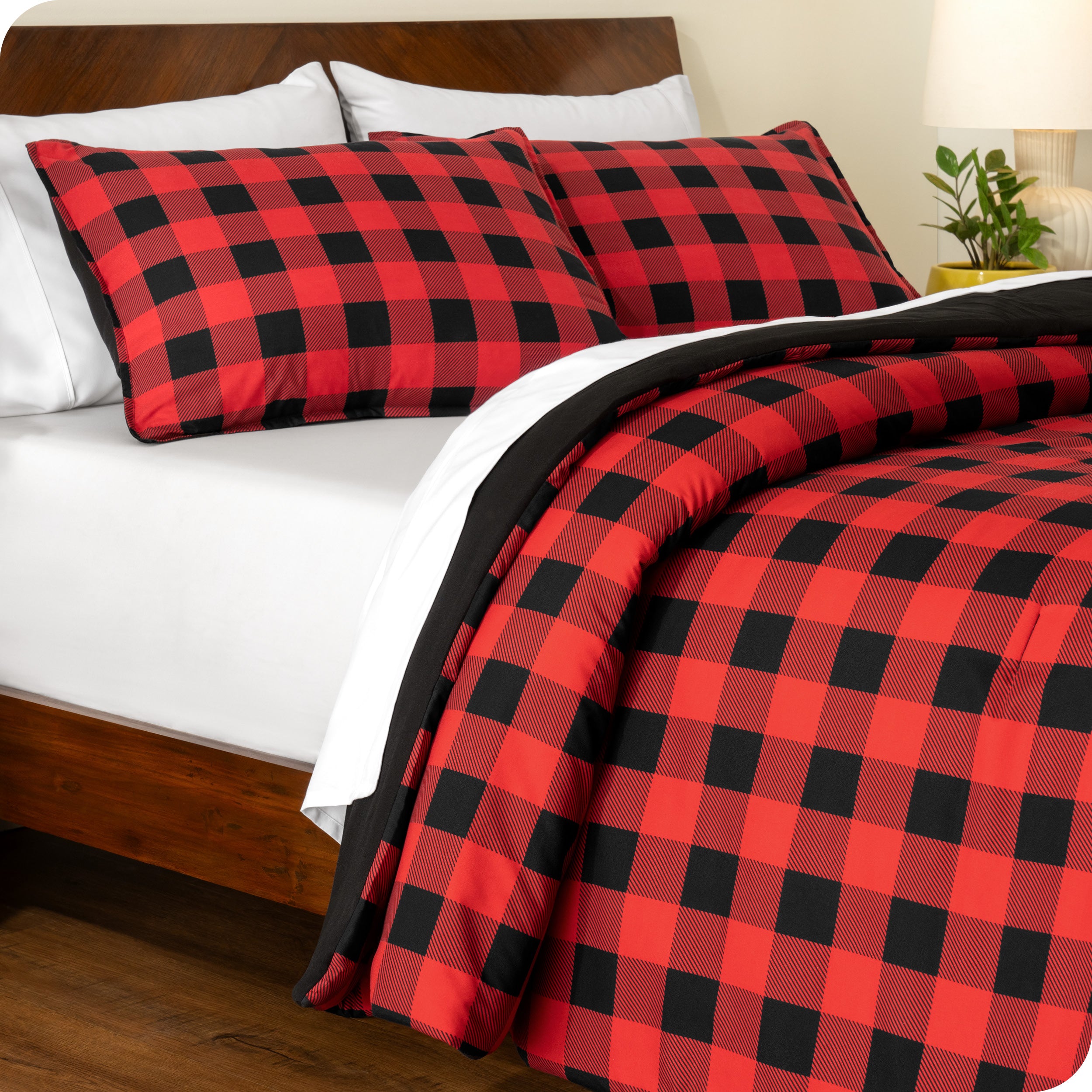 A side view of a bed made with a track stitch comforter set