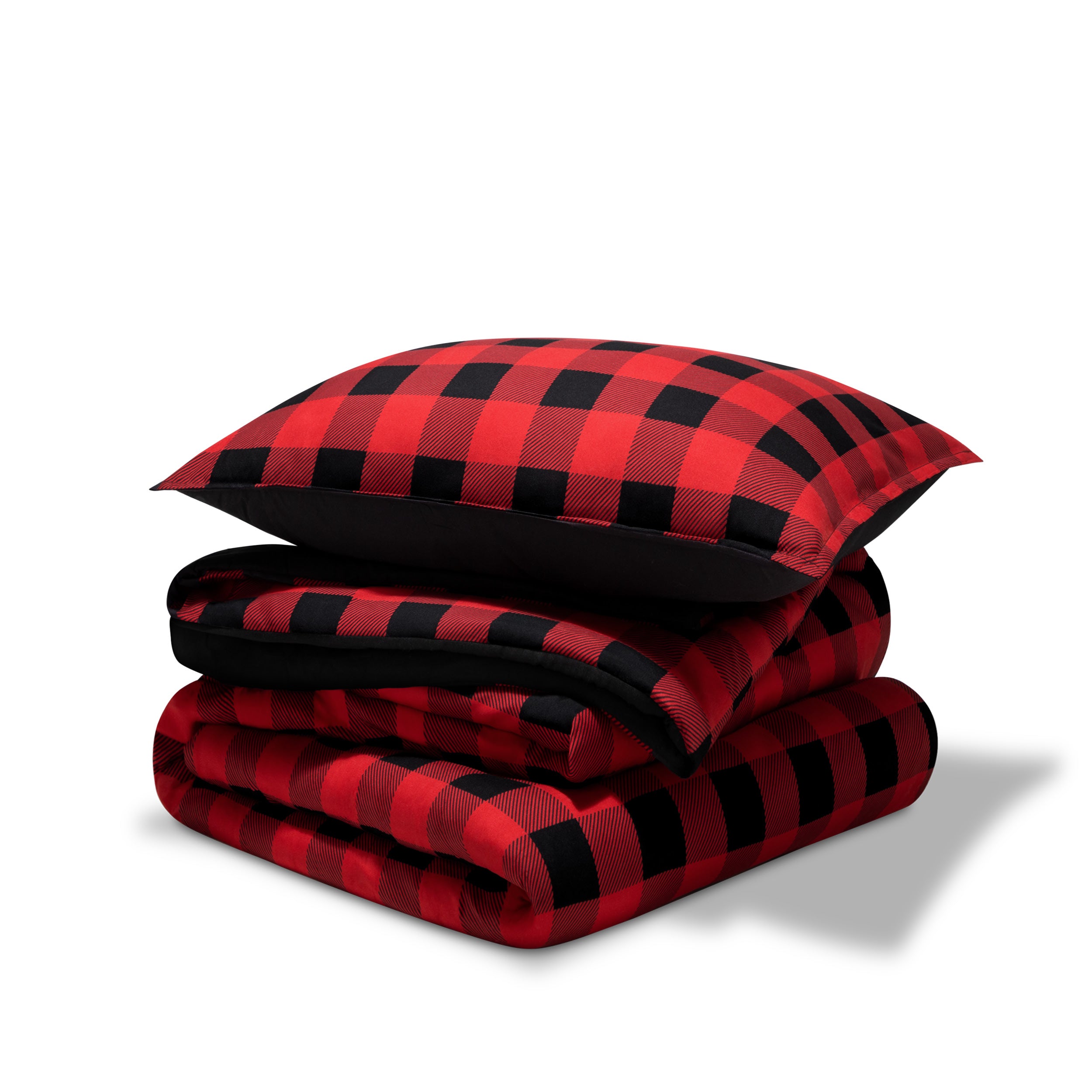A comforter folded with a matching pillow sham stacked on top