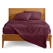 Microfiber sheet set on a bed with a wooden bed frame