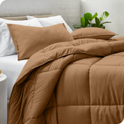 A side view of a modern bed with a comforter set and pillows on the bed