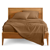 Microfiber sheet set on a bed with a wooden bed frame