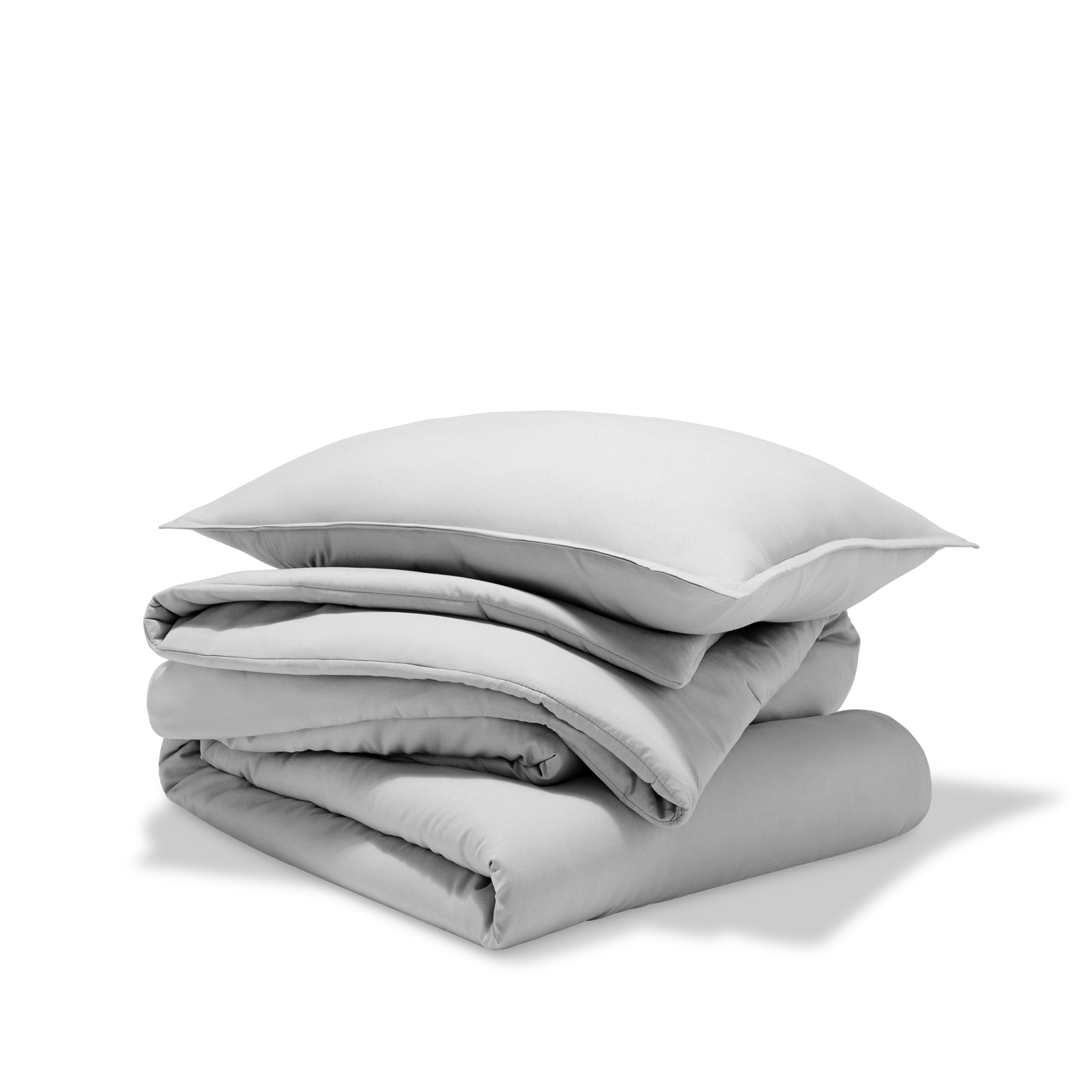 A comforter folded with a matching pillow sham stacked on top