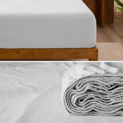 A divided image showing both the corner of a bed with organic jersey sheet and the folded sheet stacked on the bed.