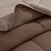 Close up of the reversible comforter showing the box stitching and the two colors