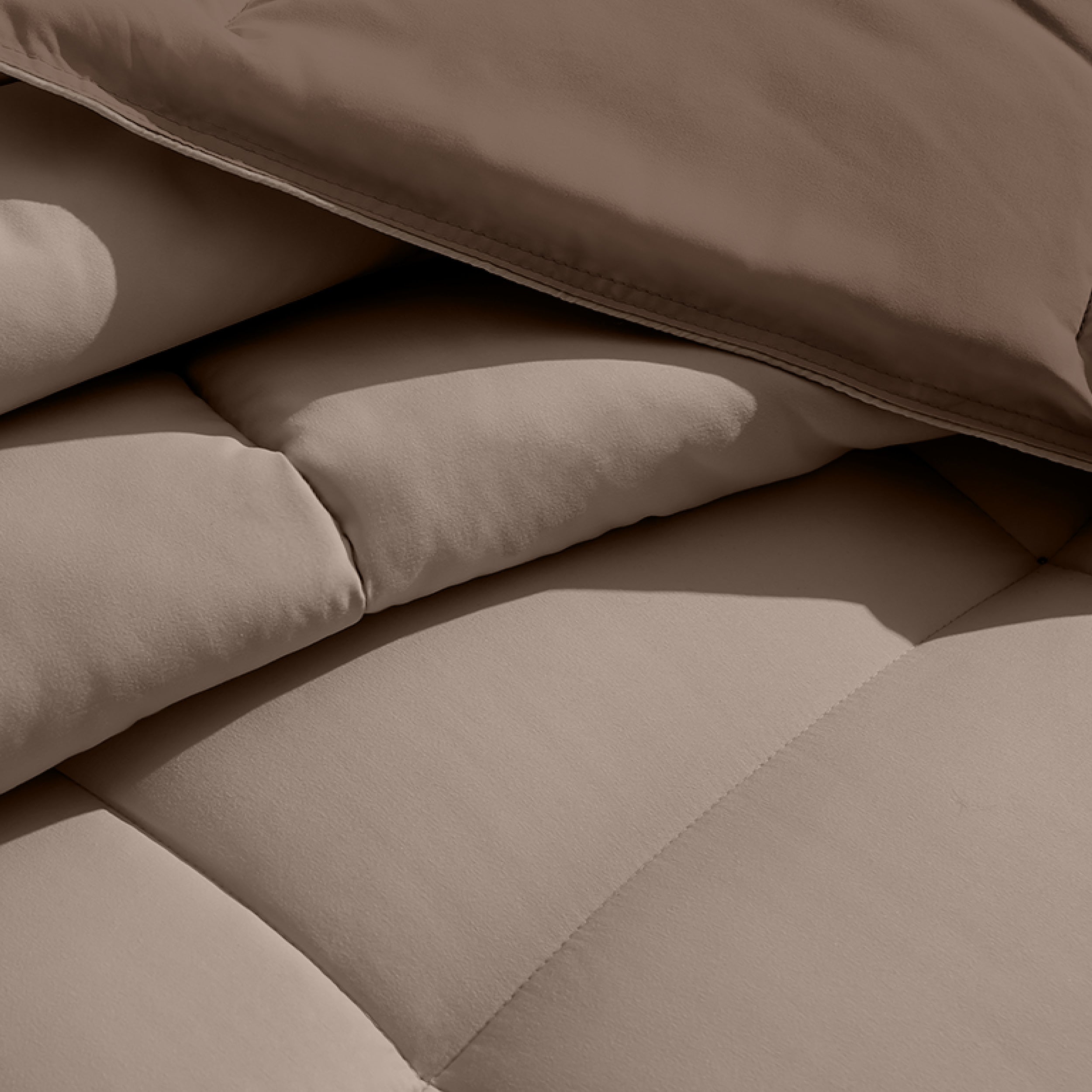 Close up of the reversible comforter showing the box stitching and the two colors