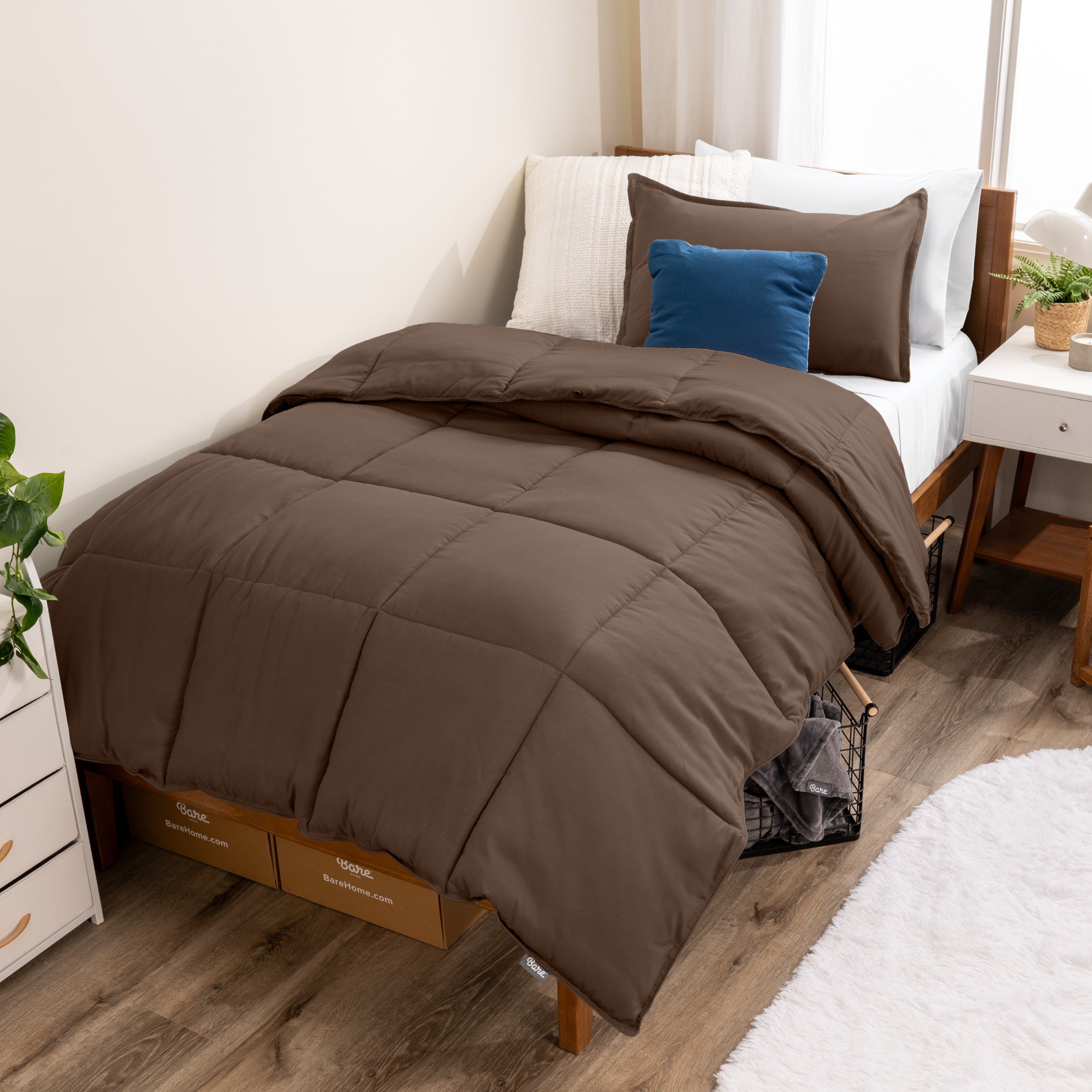 A modern bed with a down alternative comforter set on it