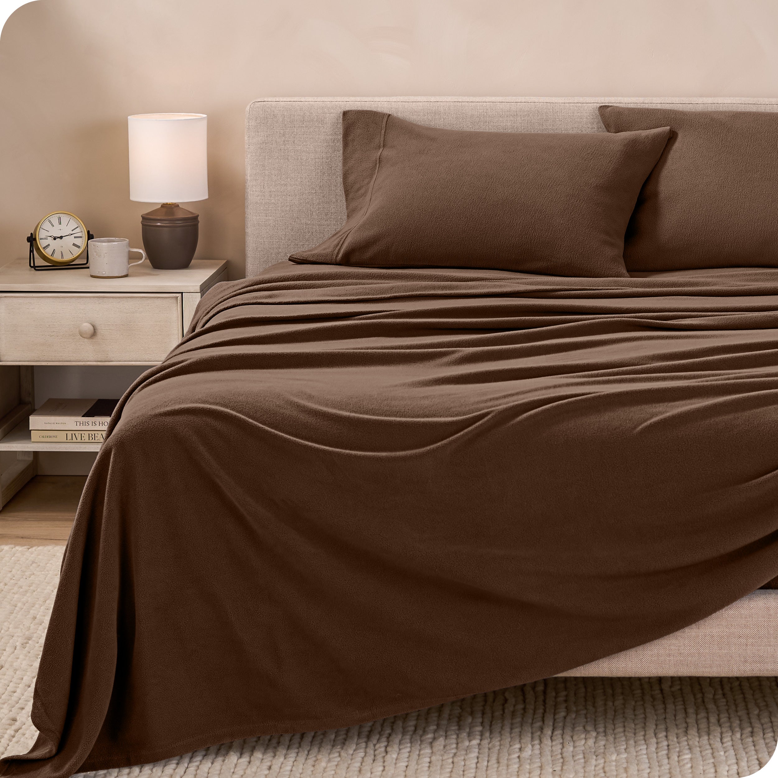 View of fleece sheets from the end of a bed with the top sheet draped over the side and end