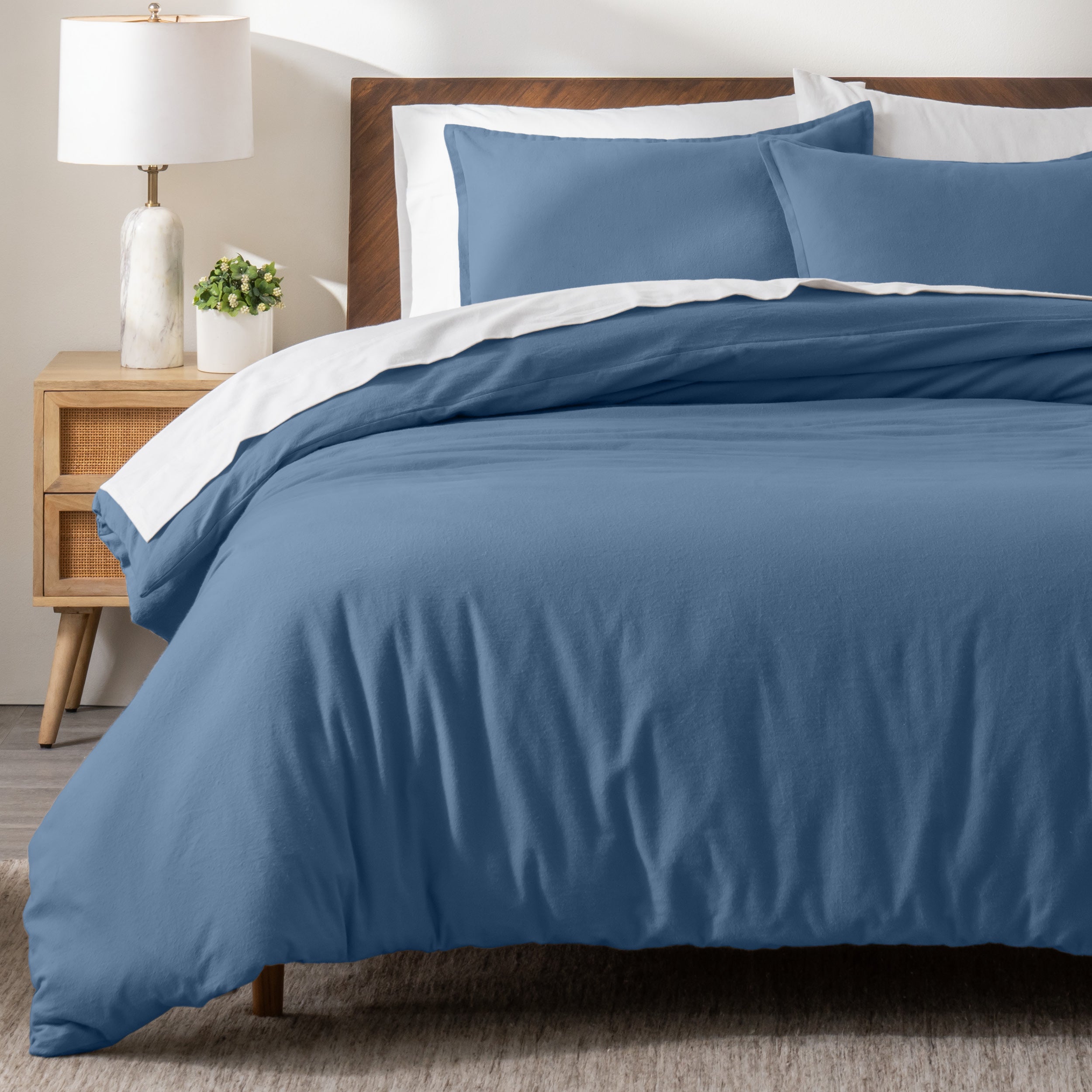 A modern bed with a flannel duvet cover set consisting of the duvet cover and two pillows.