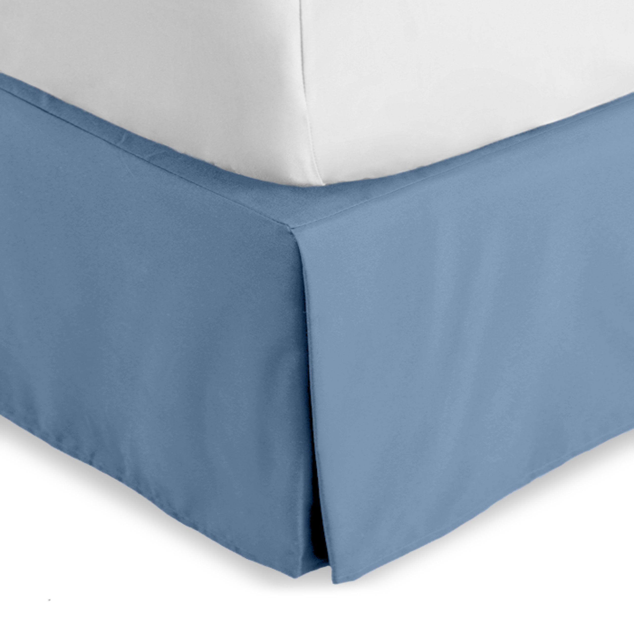 The corner of a bed skirt on a bed frame