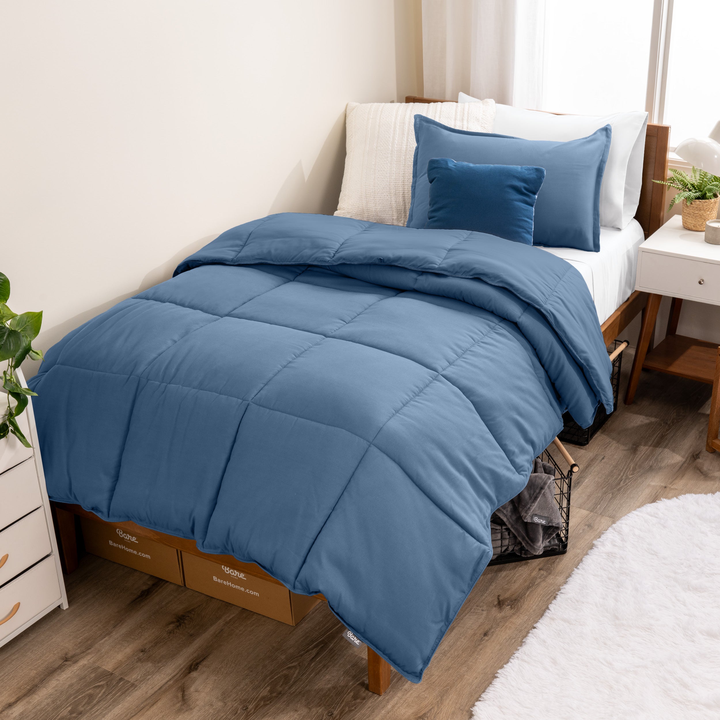 A modern bed with a down alternative comforter set on it