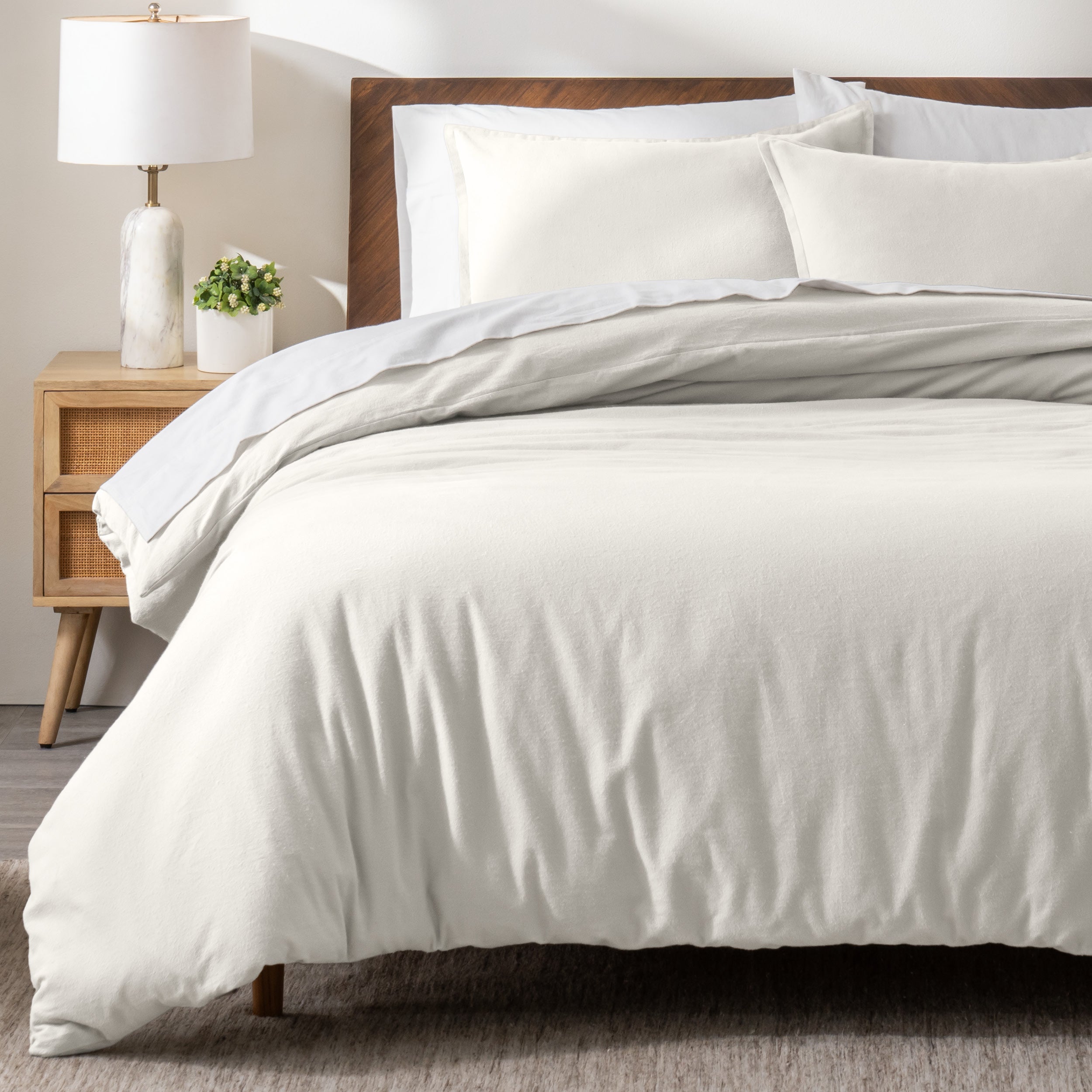 A modern bed with a flannel duvet cover set consisting of the duvet cover and two pillows.