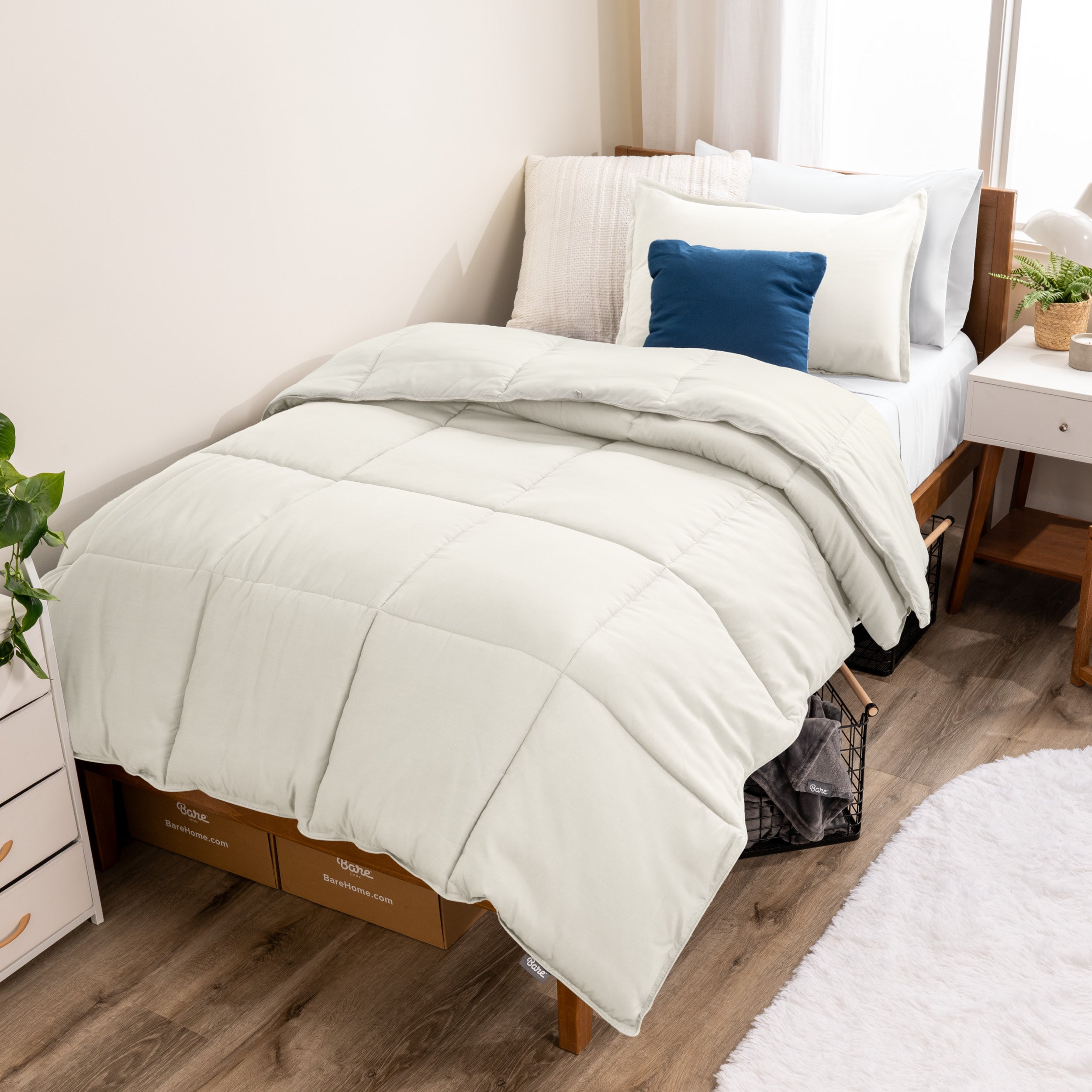 A modern bed with a down alternative comforter set on it