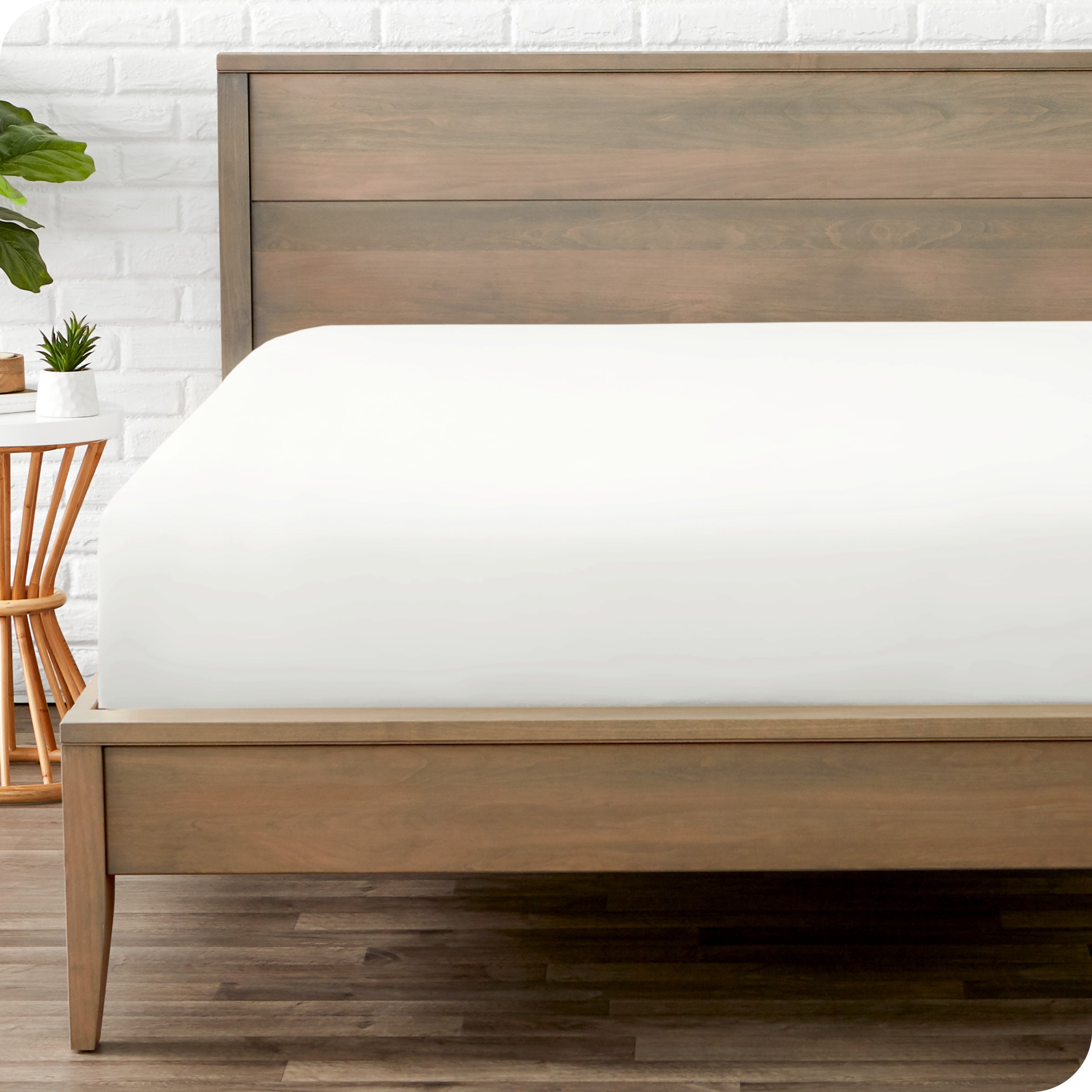 End of bed view with fitted sheet made on the mattress of a modern bed.