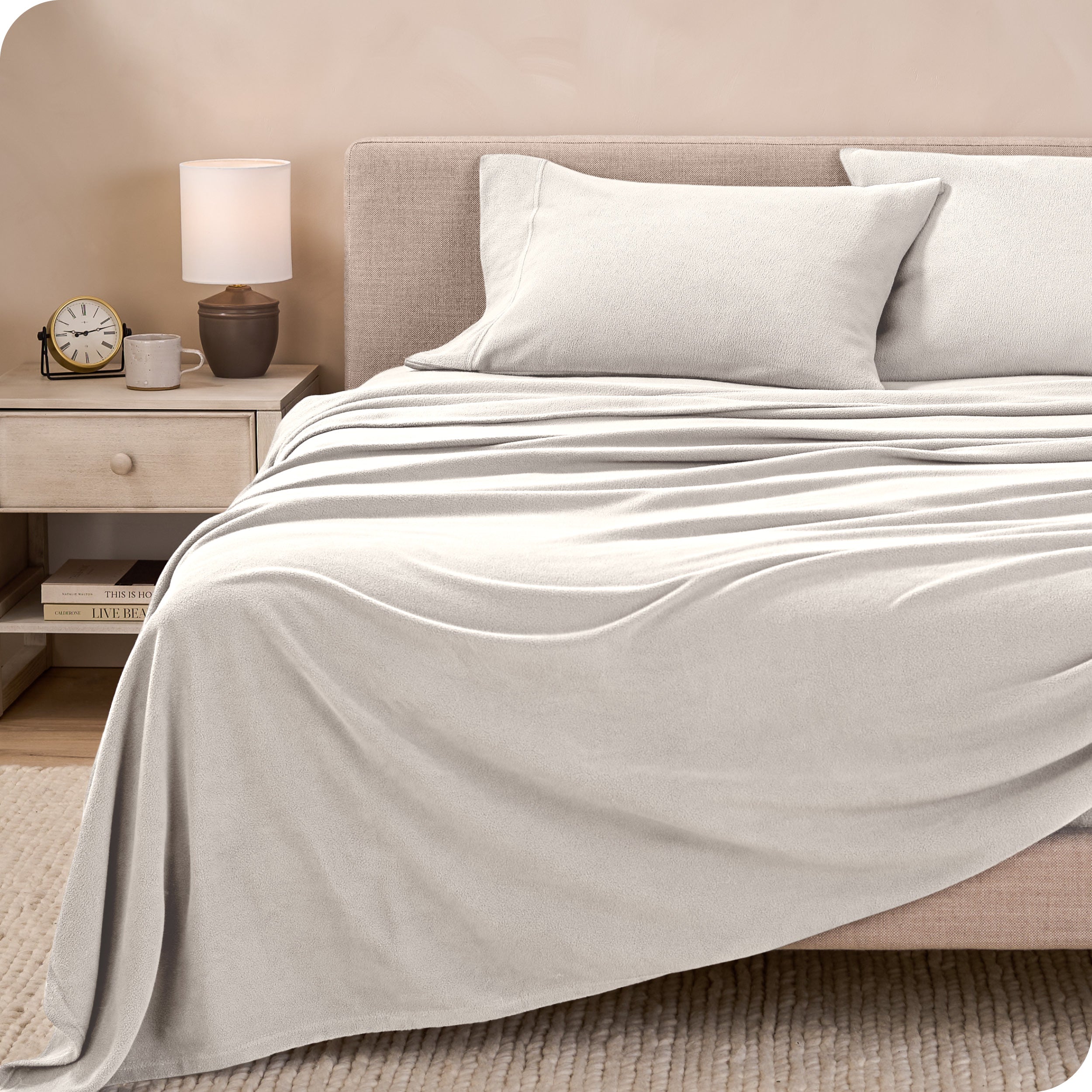 View of fleece sheets from the end of a bed with the top sheet draped over the side and end