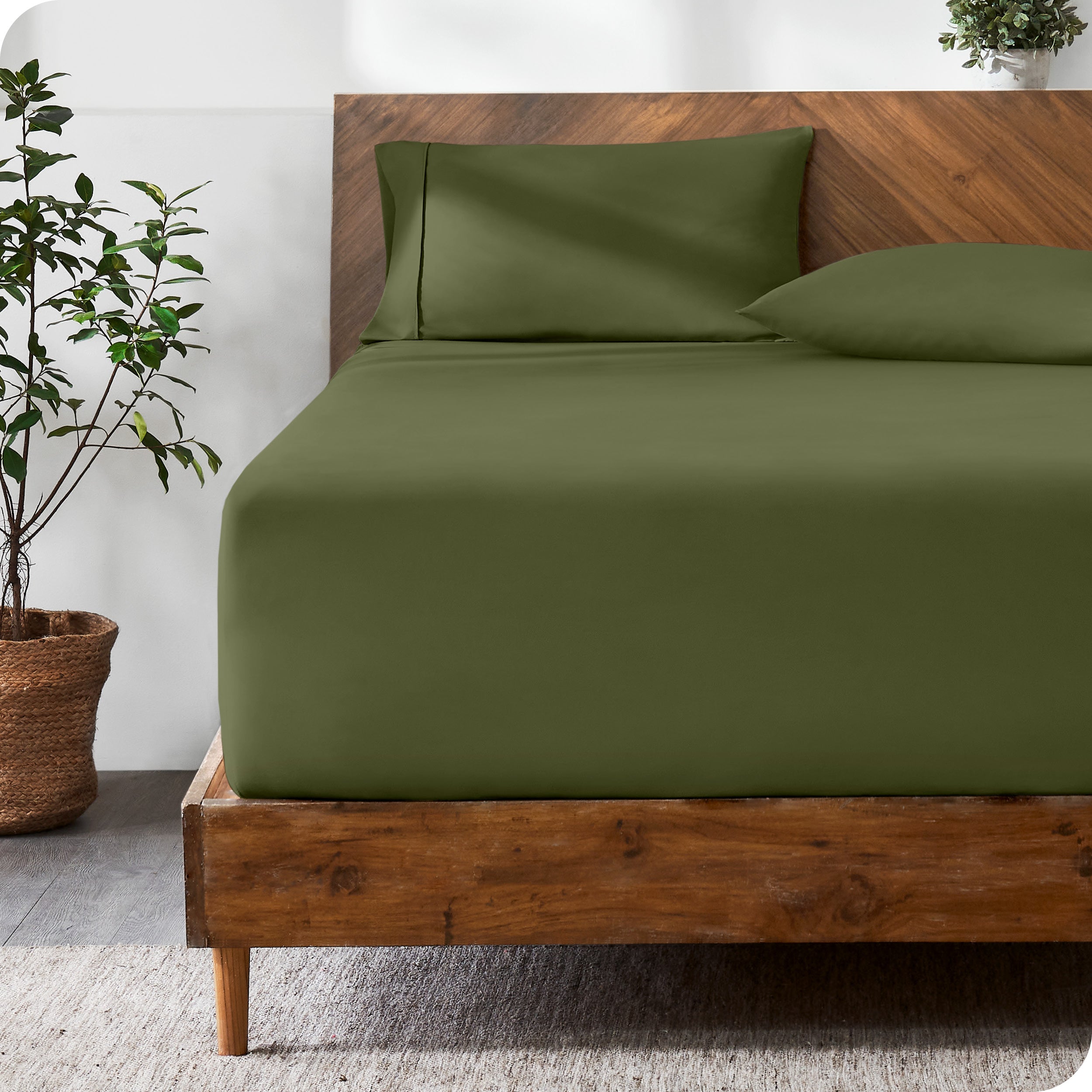 A modern bed with a fitted microfiber sheet made on the mattress.