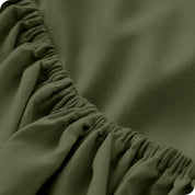 A close up of the elastic of a microfiber fitted sheet.