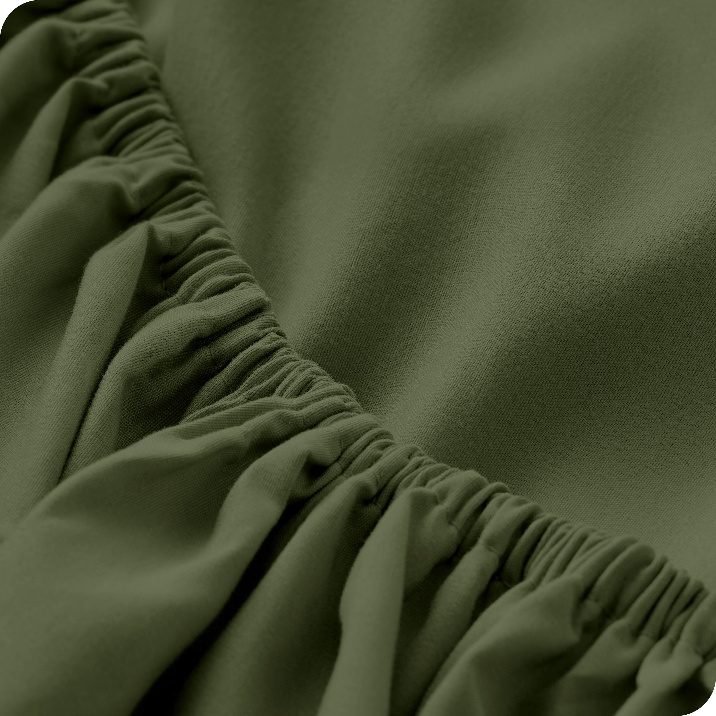 A close up of the elastic of a microfiber fitted sheet.