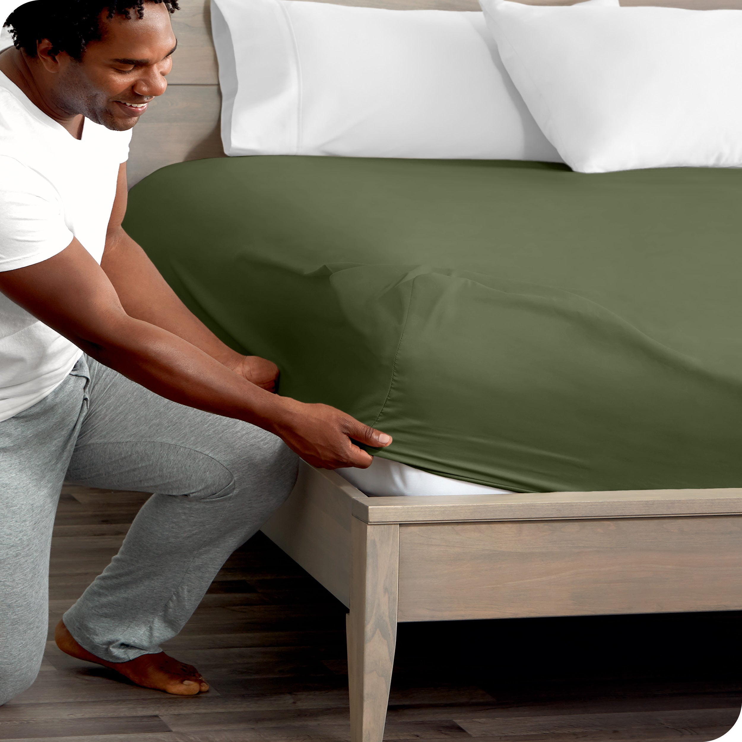 A modern bed with a fitted microfiber sheet on it