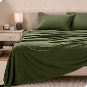 View of fleece sheets from the end of a bed with the top sheet draped over the side and end