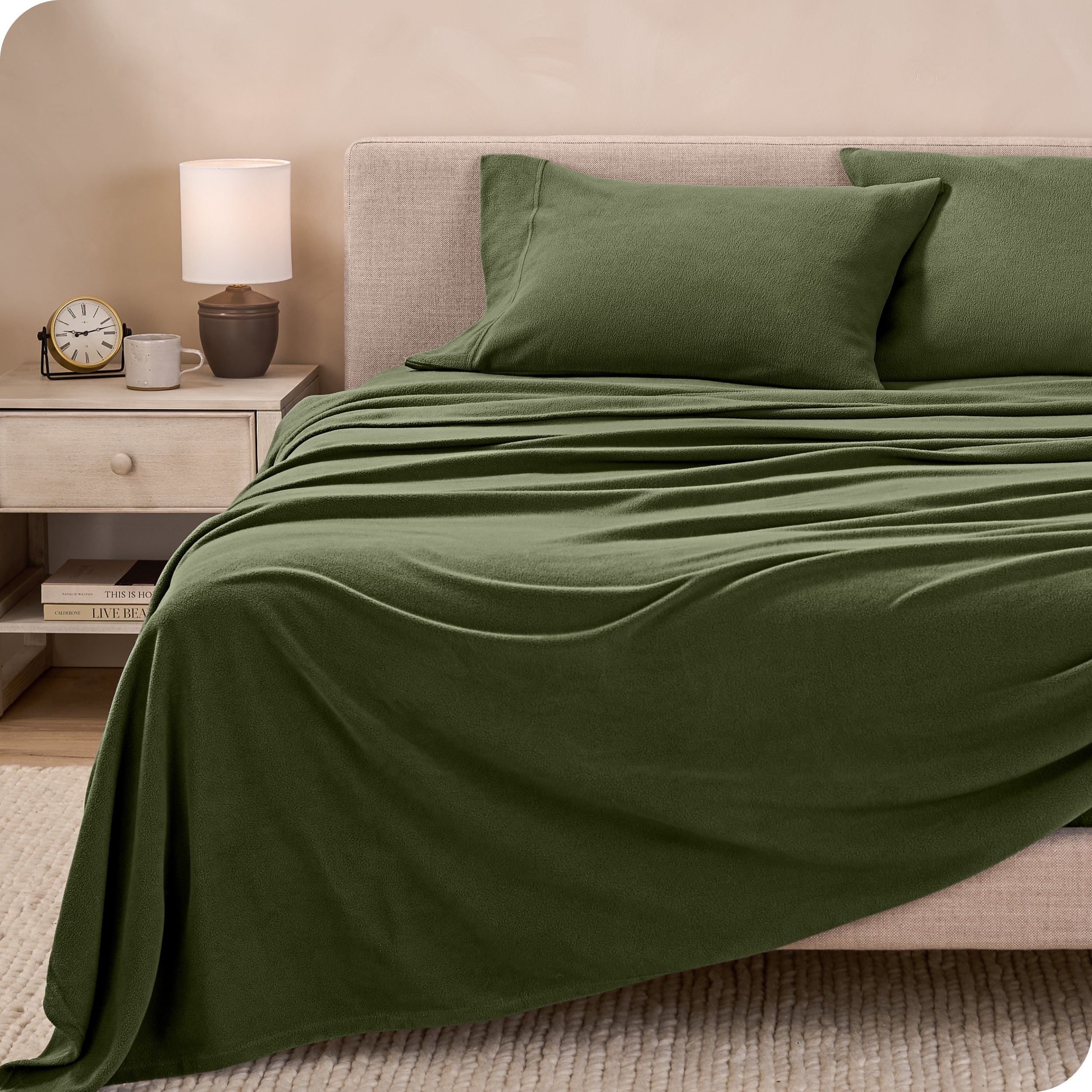 View of fleece sheets from the end of a bed with the top sheet draped over the side and end