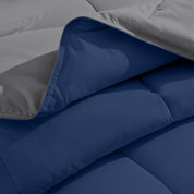 Close up of the reversible comforter showing the box stitching and the two colors