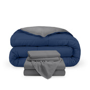 A reversible microfiber comforter and a coordinating sheet set folded and stacked