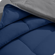 Close up of the comforter folded back showing the two different colored sides.