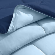 Close up of the reversible comforter showing the box stitching and the two colors