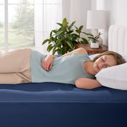 A women is sleeping on the bed with cotton mattress pad.