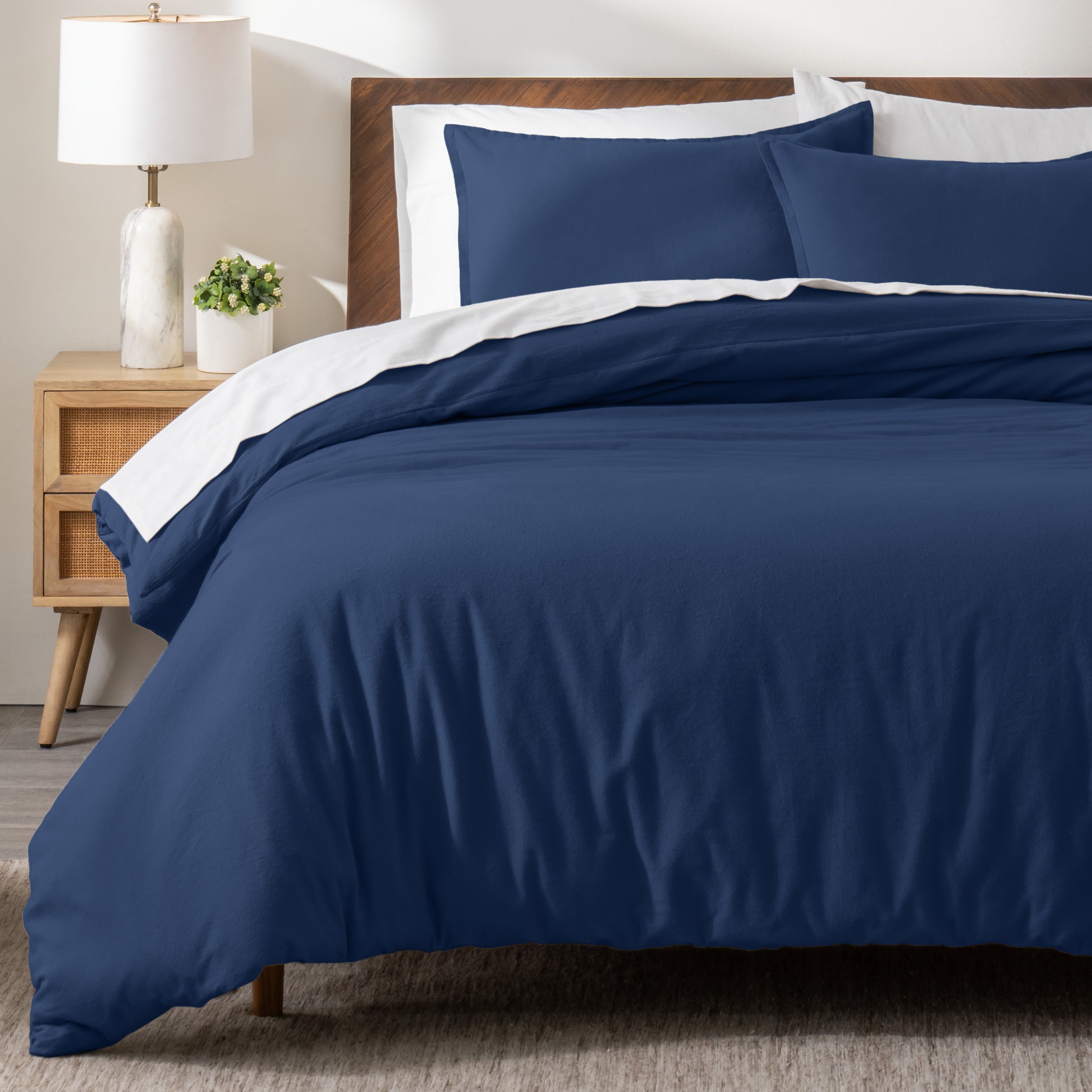 A modern bed with a flannel duvet cover set consisting of the duvet cover and two pillows.