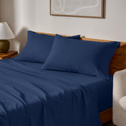 A bed made with matching flannel sheets and pillowcases