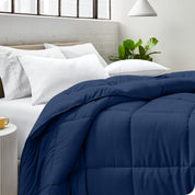 A bed made with pillows and a comforter