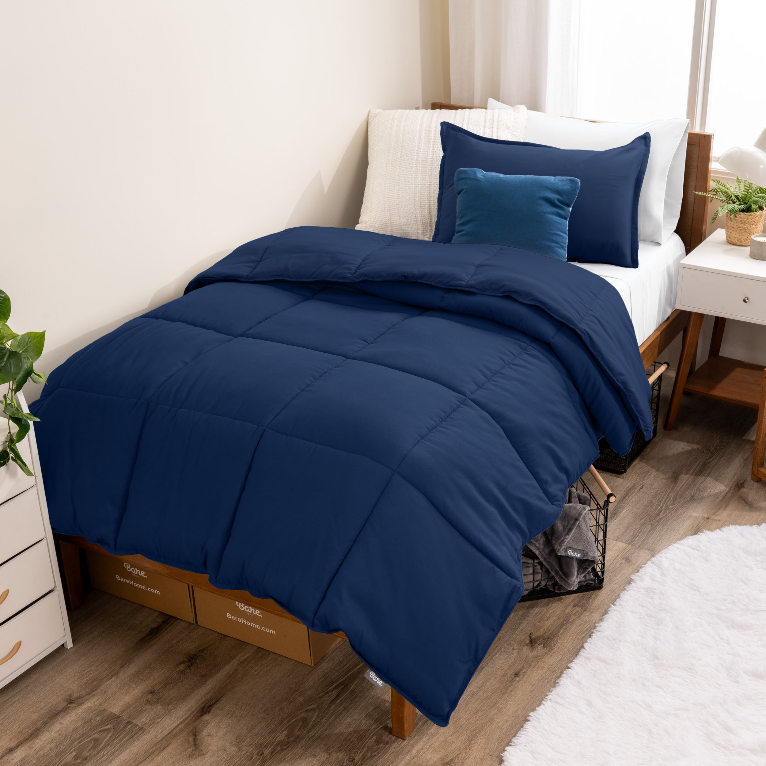 A modern bed with a down alternative comforter set on it